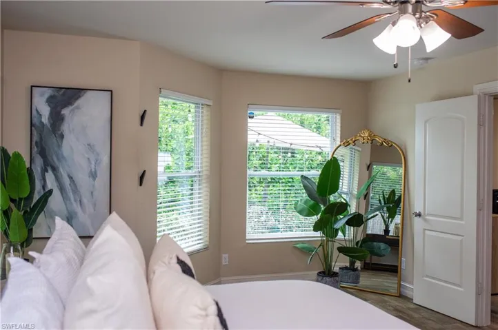 Bedroom with a ceiling fan and wood tile finished floors