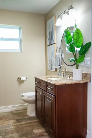 Bath with vanity and wood tile finished floors