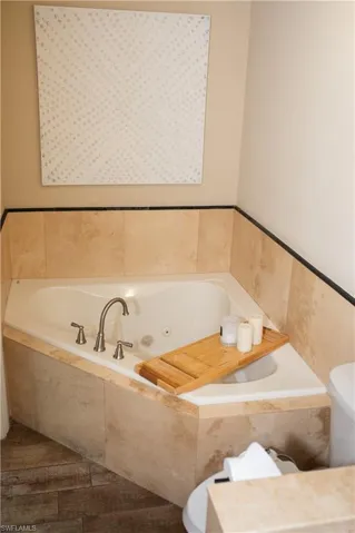 Master bath with a whirlpool tub and toilet