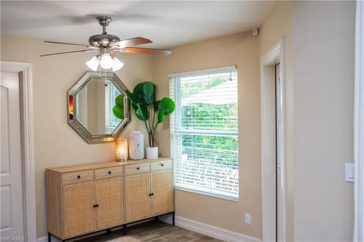 Breakfast nook area with wood-style tile floors and ceiling fan