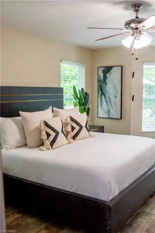 Bedroom featuring ceiling fan and multiple windows