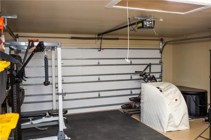 Air-conditioned Garage featuring a garage door opener