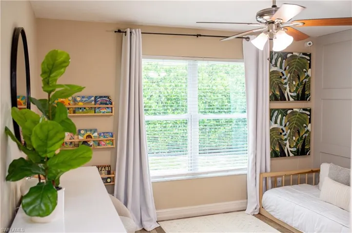 Bedroom with baseboards and a ceiling fan