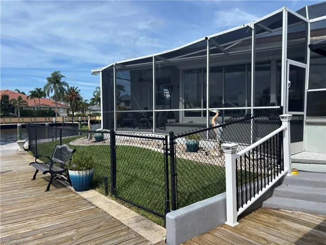 View of home's exterior featuring glass enclosure and a patio area