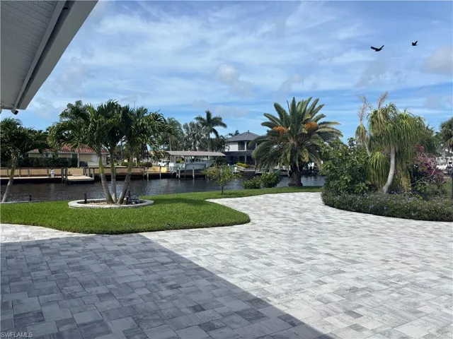 View of property's community featuring a yard and a water view
