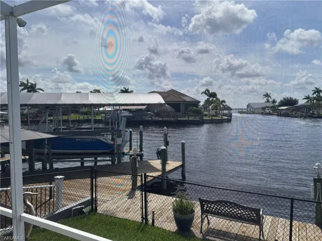 Dock featuring boat lift and a water view