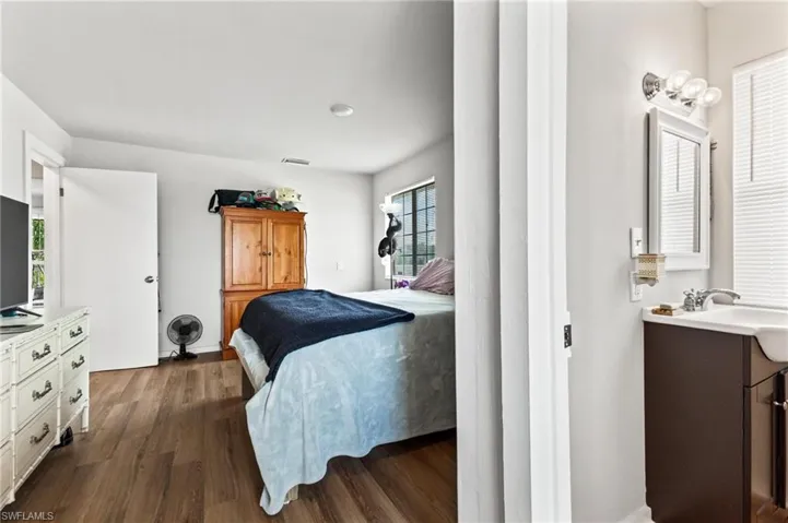 Bedroom featuring dark hardwood / wood-style floors and sink