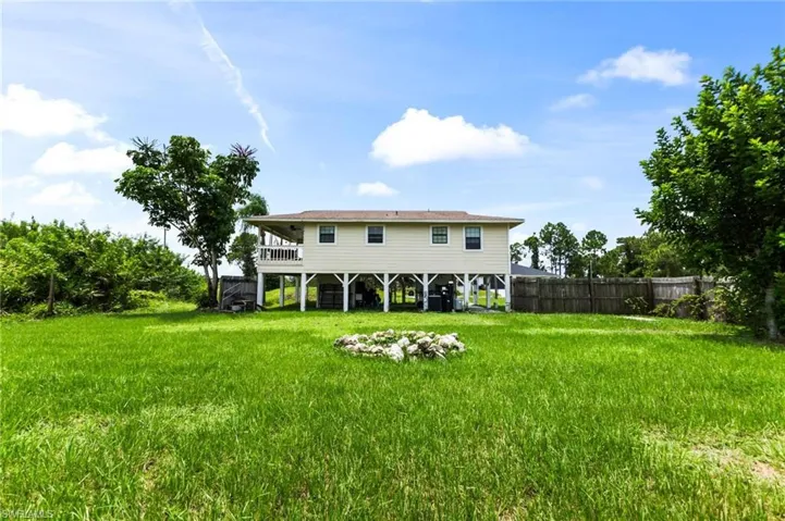 Back of property with a yard