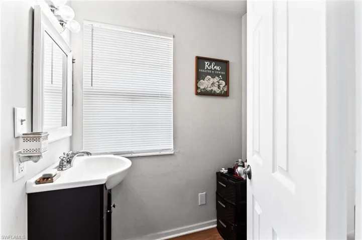 Bathroom with vanity and wood-type flooring