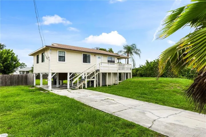 Rear view of house with a yard