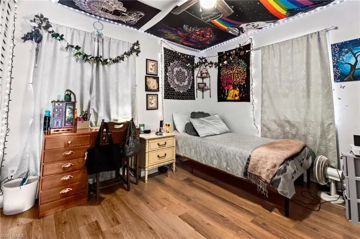 Bedroom featuring ceiling fan and hardwood / wood-style floors