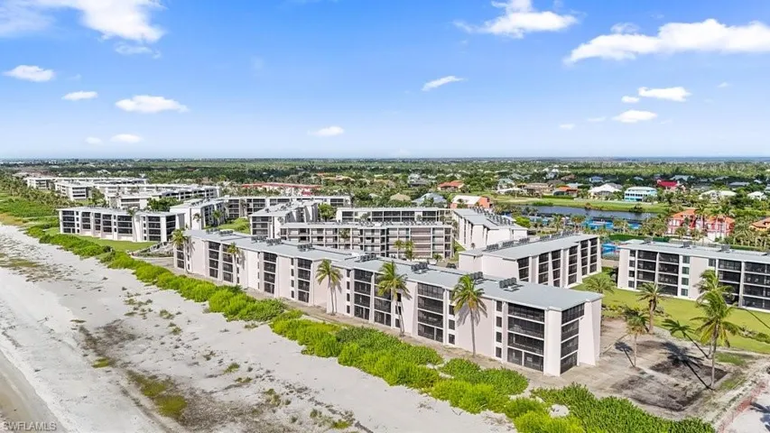 Bird's eye view of a nearby body of water and apartment complex / building