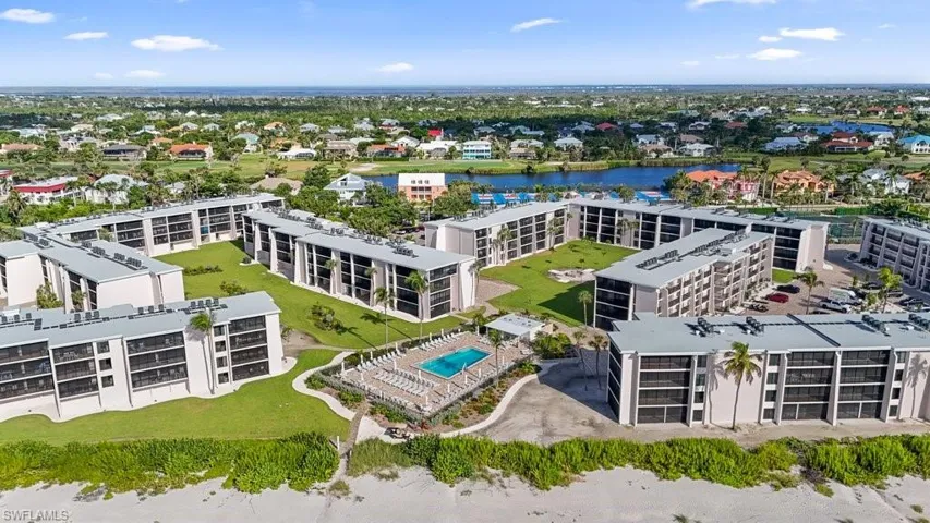 Drone / aerial view of a pool and a large body of water
