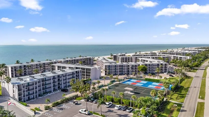 Drone / aerial view of a nearby body of water and apartment complex