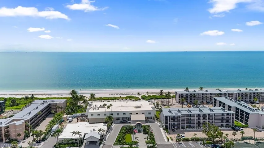 Bird's eye view of unending shoreline and apartment complex / building