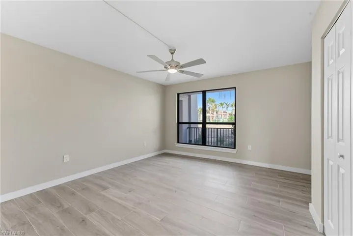Unfurnished bedroom with a closet, wood tiled floors, and ceiling fan
