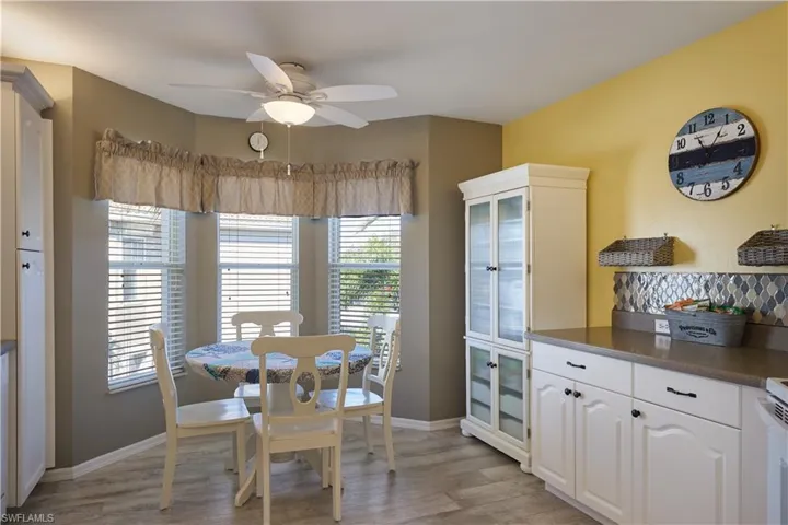 Dining area with ceiling fan and light hardwood / wood-style floors
