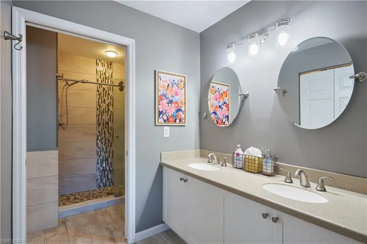 Bathroom with a tile shower and vanity