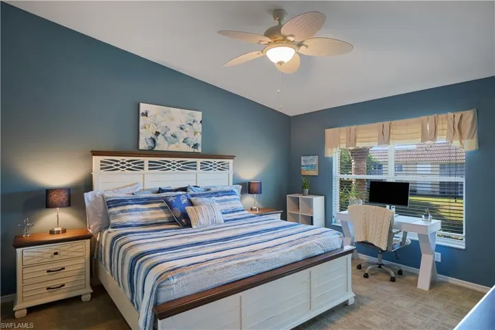 Bedroom featuring ceiling fan, carpet floors, and lofted ceiling
