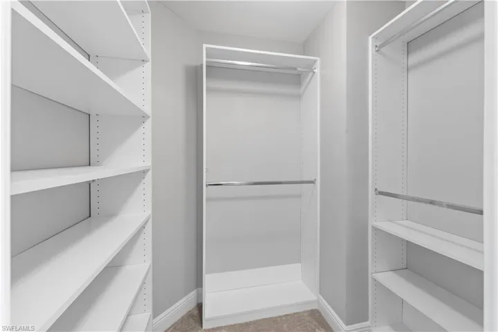 Spacious closet featuring Built in shelving