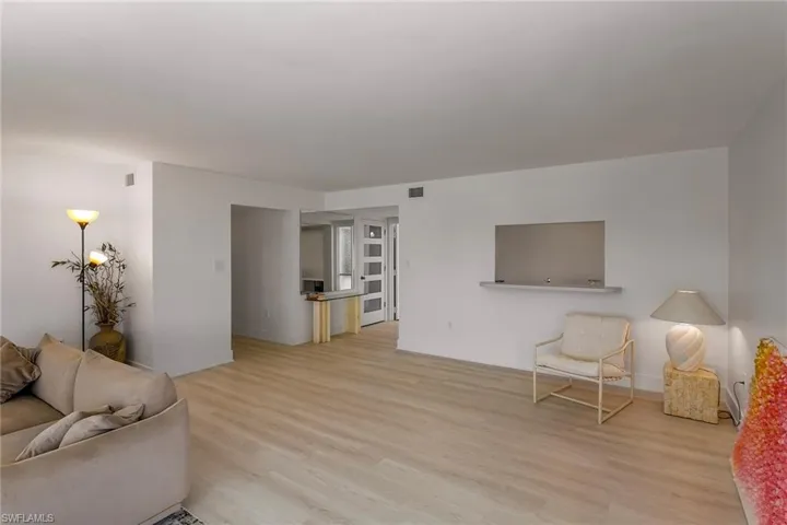 Living area featuring light wood-style floors and baseboards