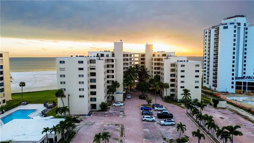 View of property featuring uncovered parking and a water view