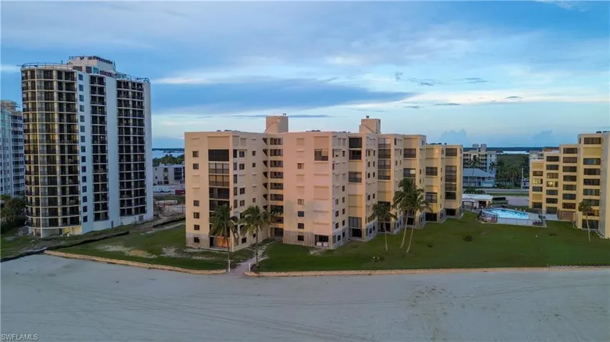 View of building exterior featuring view of water and beach