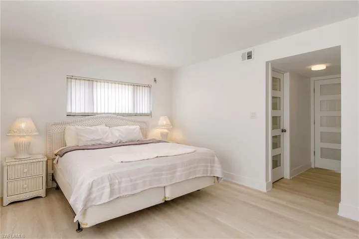 Bedroom featuring light wood-type flooring and baseboards