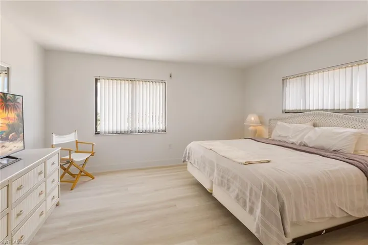 Bedroom featuring light wood-style floors and multiple windows