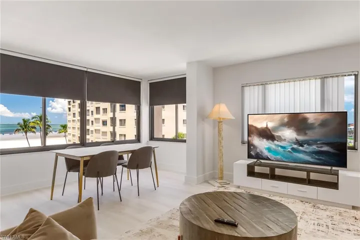 Living room featuring plenty of natural light, wood finished floors, and a water view