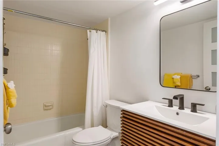 Bathroom with shower / bath combo and vanity
