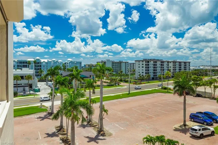 View of community featuring uncovered parking