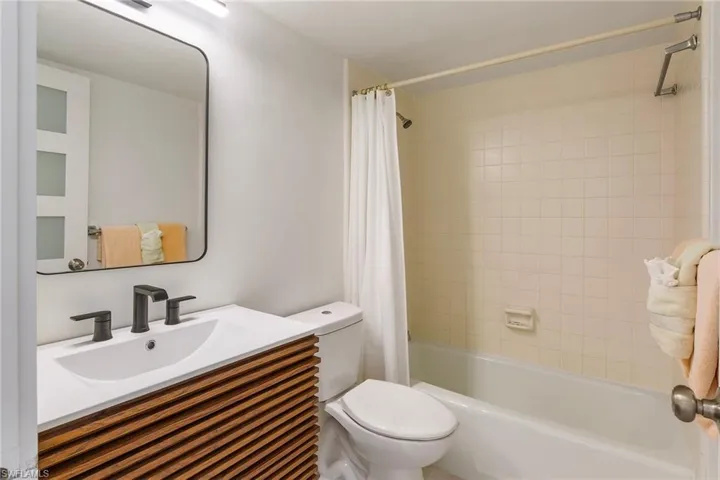 Full bath with vanity and shower / bath combo with shower curtain