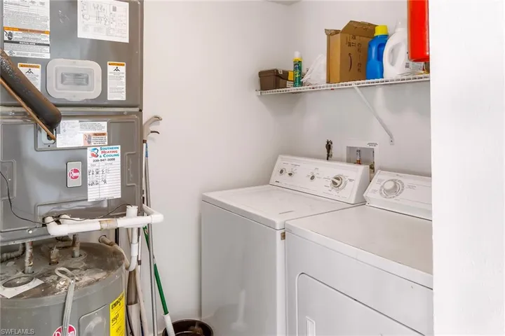 Washroom featuring heating unit and separate washer and dryer