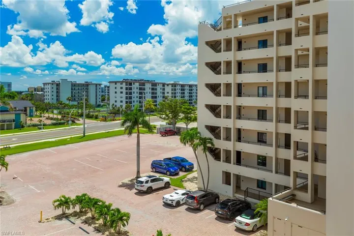 View of building exterior with uncovered parking
