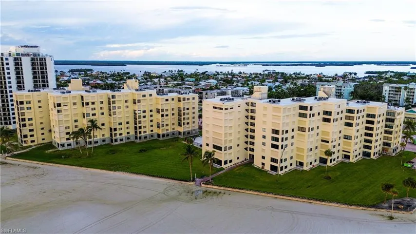 Drone / aerial view of a large body of water and apartment complex