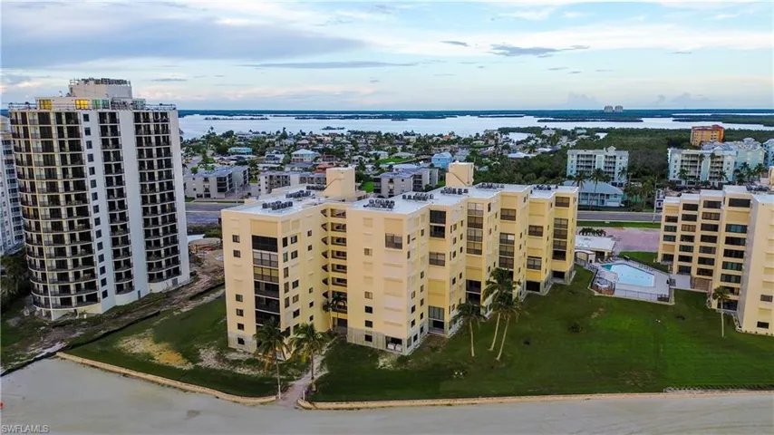 Drone / aerial view of a large body of water and apartment complex