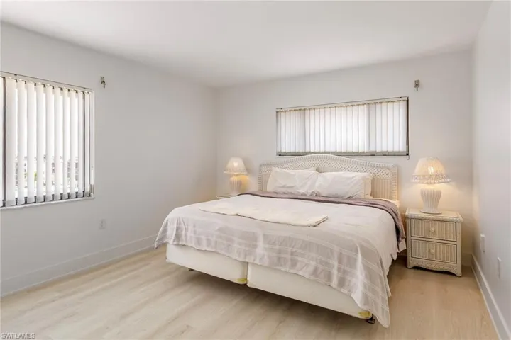 Bedroom with wood finished floors and baseboards