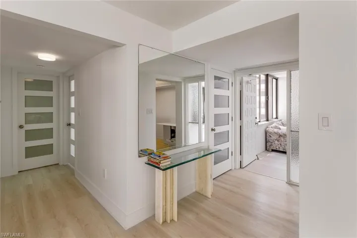 Hall featuring light wood-style floors and baseboards