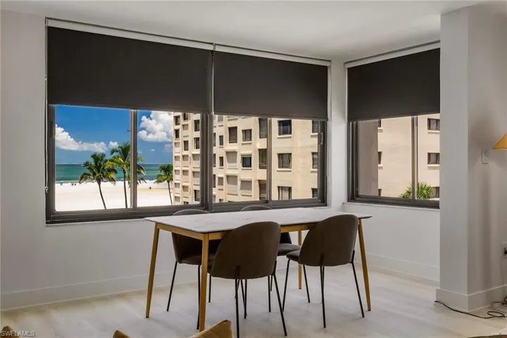 Dining space featuring view of water and beach and wood finished floors