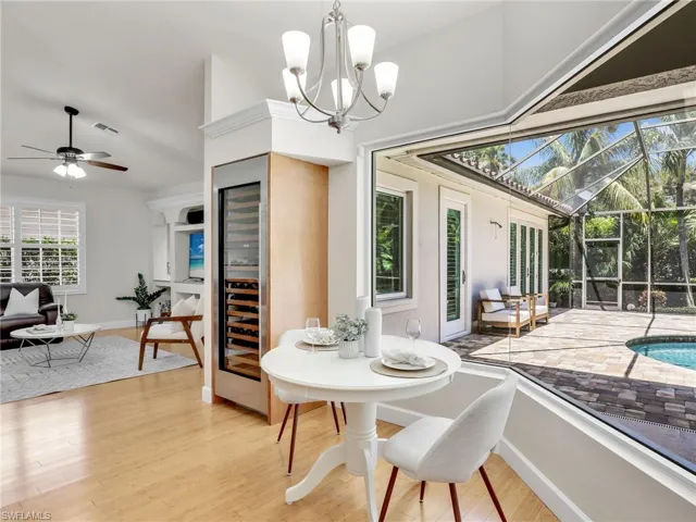 Living room featuring high vaulted ceiling, ceiling fan, and light hardwood / wood-style floors