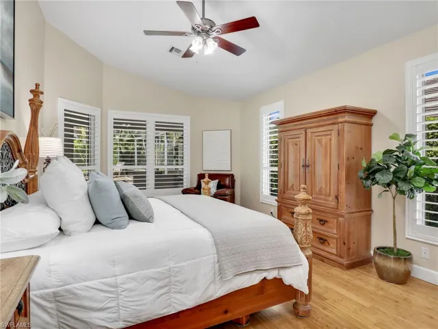 Bedroom with ceiling fan, high vaulted ceiling, and light hardwood / wood-style flooring