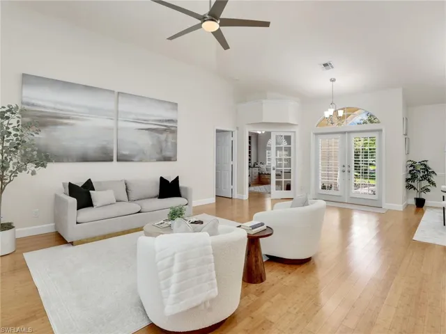 Dining space with a notable chandelier, light wood-type flooring, and plenty of natural light