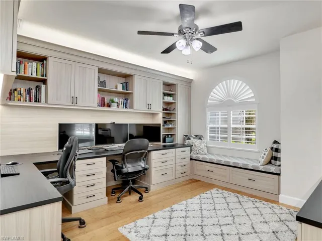 Office with french doors and light hardwood / wood-style floors