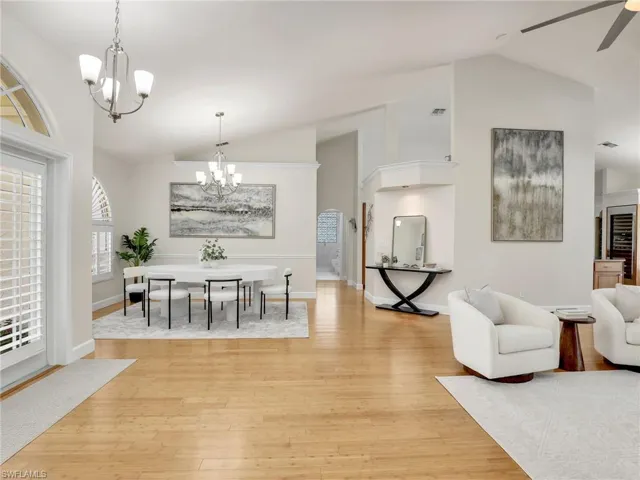 Living room with ceiling fan, light hardwood / wood-style flooring, and built in features