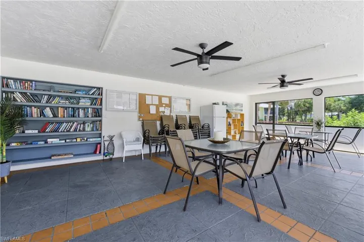 Covered outdoor area featuring dark gray textured tile flooring with orange accent stripes
