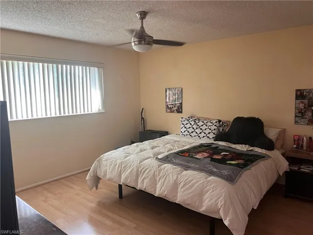 Master Bedroom with light hardwood / wood-style flooring