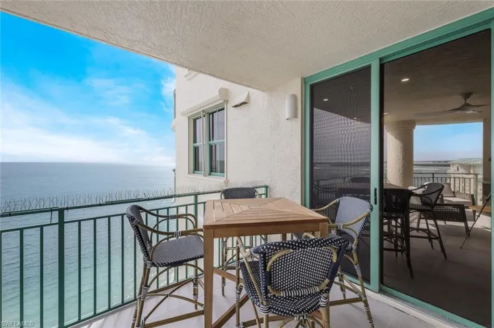 Balcony with a water view and a sunroom