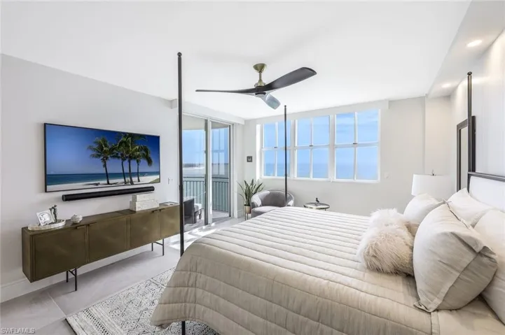 Bedroom featuring ceiling fan, floor to ceiling windows, and access to outside