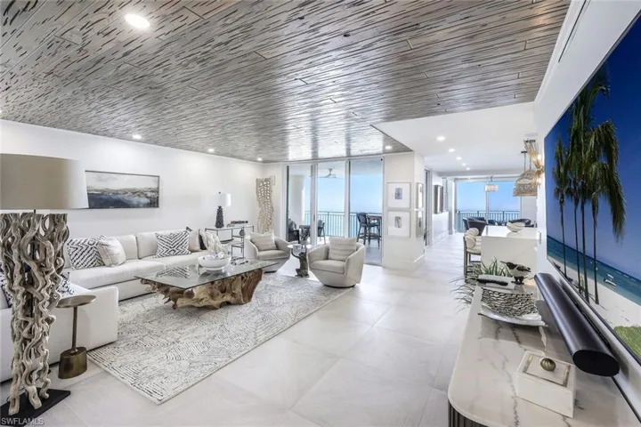 Living area featuring a wall of windows and recessed lighting